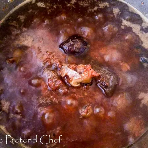 red ofada stew boiling in a pot