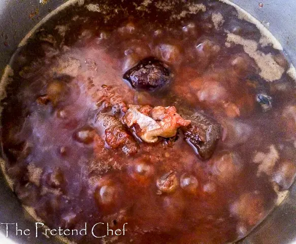 red ofada stew boiling in a pot