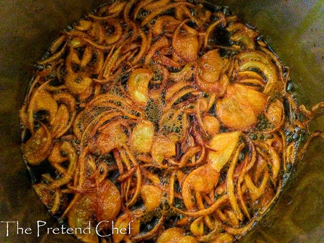 onions frying in hot oil for agoyin stew (ewa agoyin)