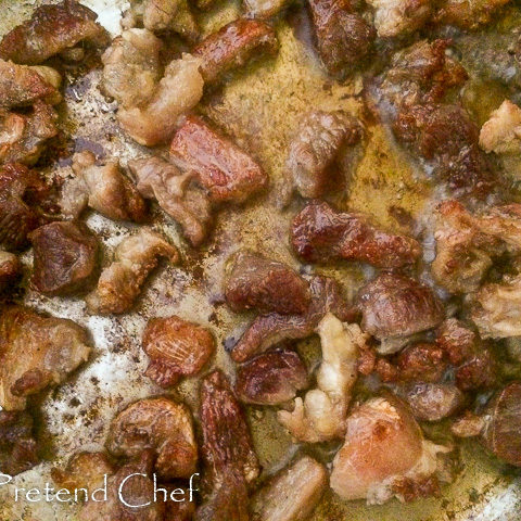 beef frying in a saucepan