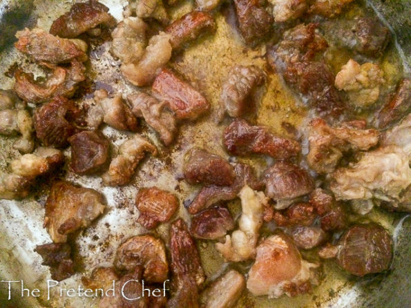 beef frying in a saucepan