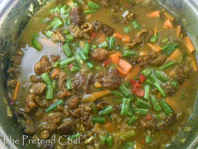 vegetables added to simple curry sauce in a saucepan