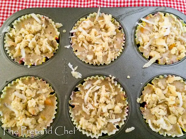 mango muffin with coconut crumbs in muffin tin