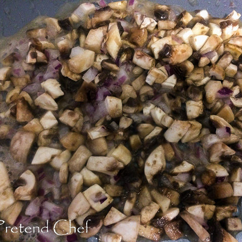 chopped mushrooms frying in a frying pan