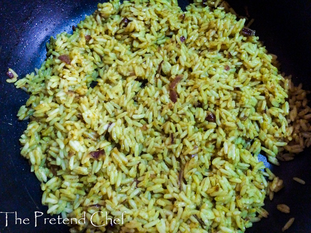 Nigerian green curry rice in a frying pan