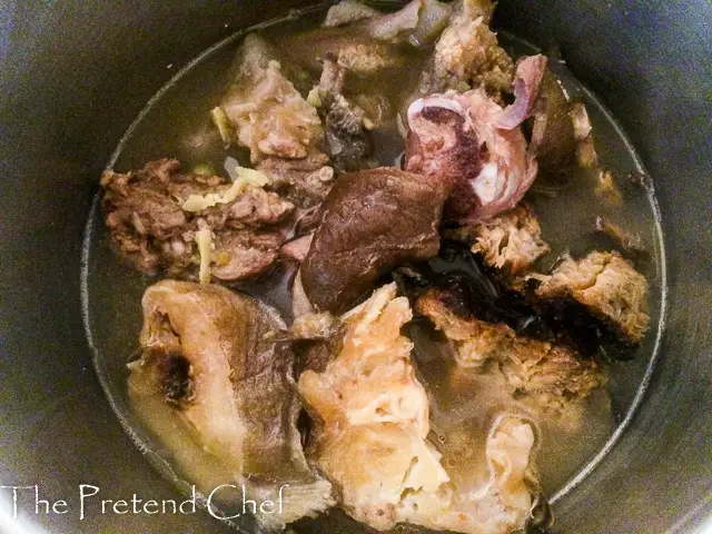 meat, stockfish and dry fish cooking in a pot