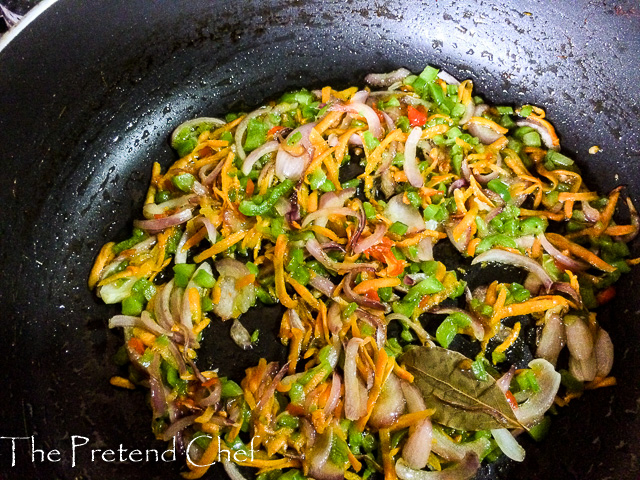 Shredded vegetables frying in a frying pan