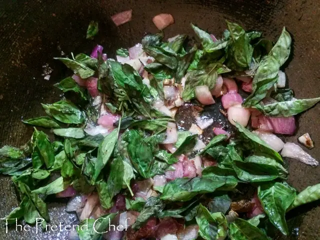 fish curry leaf rice cooking in a saucepan