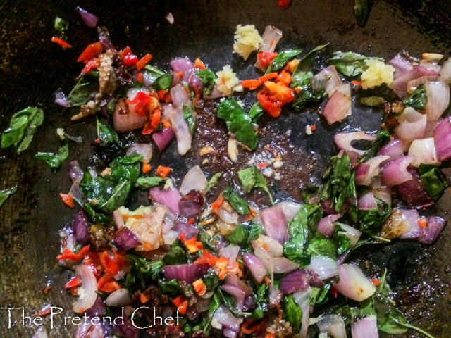 fish curry leaf rice cooking in a saucepan