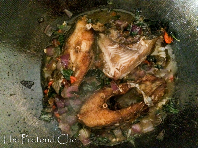 fish curry leaf rice cooking in a saucepan