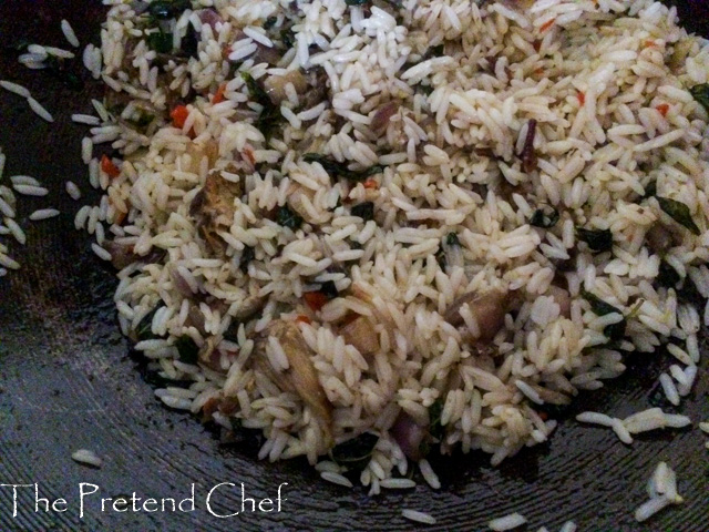 fish curry leaf rice cooking in a saucepan