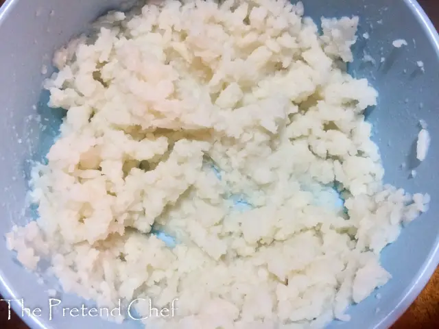 slightly mashed cooked rice in a bowl