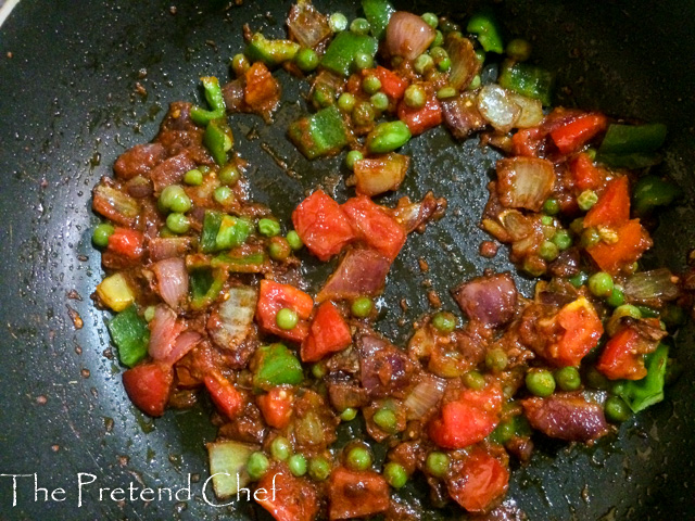 vegetables sauteing in a frying pan for Nigerian Tomato Rice recipe using leftover rice