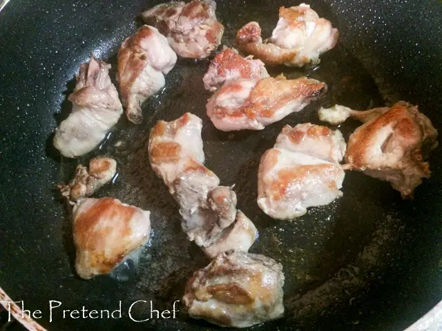 chicken pieces frying in a frying pan