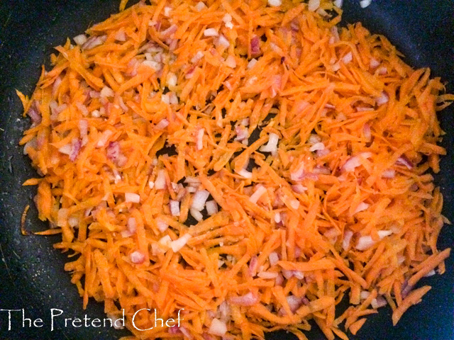 shredded carrot in frying pan