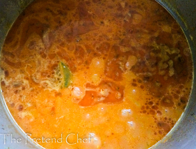 Nigerian coconut jollof rice cooking in a pot