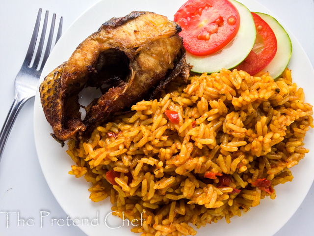 Nigerian coconut jollof rice in a plate with fish and vegetables