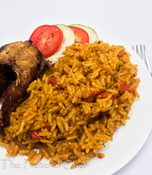 Nigerian coconut jollof rice in a plate with fish and vegetables