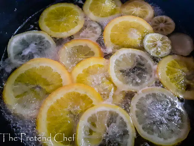 citrus slices simmering in syrup