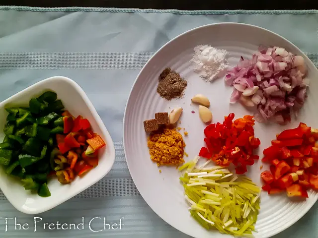 ingredients for Jamaican brown stew chicken in a plate