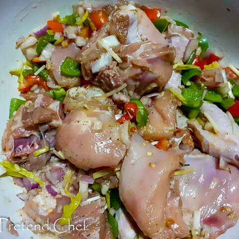 chicken parts marinate in a bowl