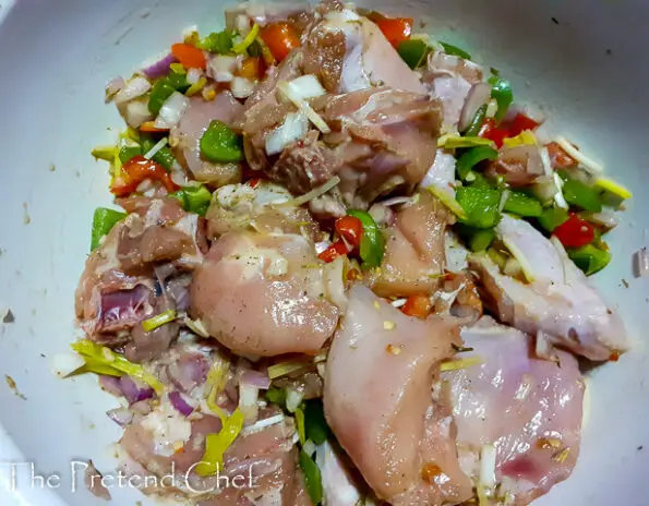 chicken parts marinate in a bowl