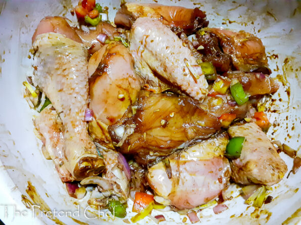 chicken parts marinate in a bowl