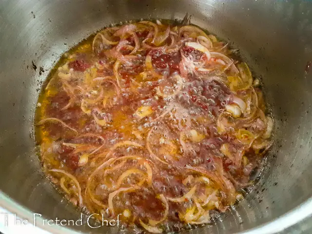 sliced onions frying in hot palm oil.