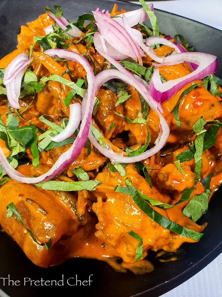 Delicious Nkwobi (cowleg) in a plate with red onions and utazi