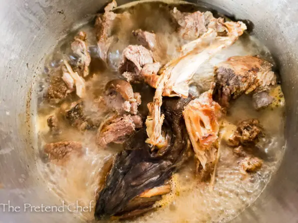 Meat, stockfish and fish boiling in a pot
