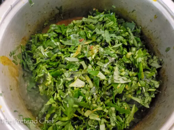Waterleaf added to pot of soup