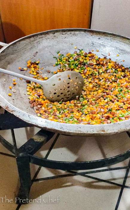 chopped vegetables frying in a large frying pan