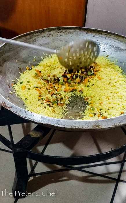 vegetables being added to Nigerian fried rice