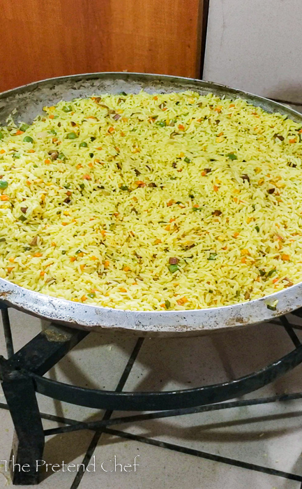 Nigerian Fried Rice for 100 people in a large frying pan