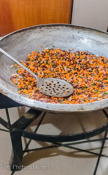 chopped vegetables frying in a large frying pan