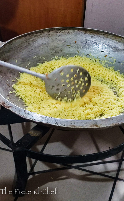 Rice frying in large frying pan