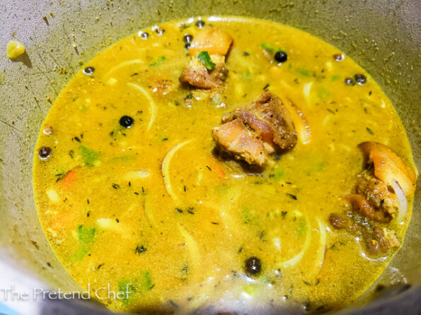 Jamaican Curry Oxtail boiling in a pot