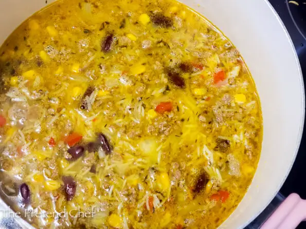 Nigerian dirty rice in a pot with stock