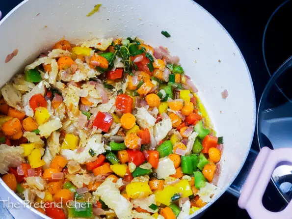chopped vegetables and saltfishfrying in oil