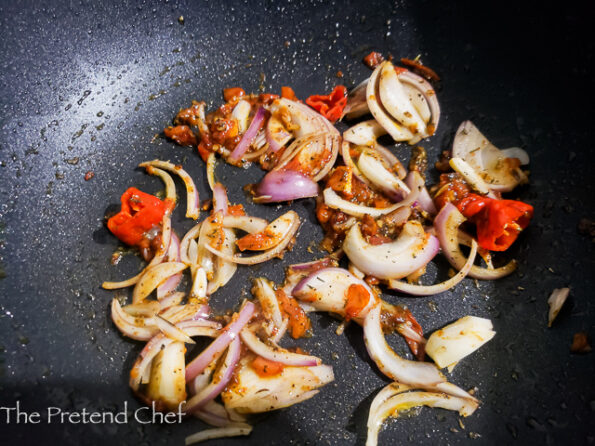 chopped Tomato, onions and scotch bonnet in a sauce pan