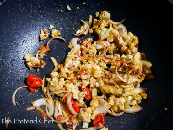 Saltfish frying in a pan